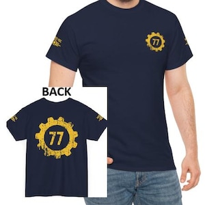 May include: Navy blue t-shirt with a yellow gear design and the number 77. The design is on the front and back of the shirt. The shirt also has a small logo on the left sleeve.