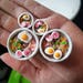 Ramen Plugs Polymer clay in a stainless steel tunnel, miniature food polymer clay plugs. 
