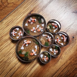 Koi fish pond plugs, polymer clay and resin in a stainless steel plug