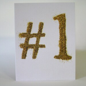 Nummer 1 Inspirationskarte #1 gold glitzernd auf creme/grauem Hintergrund