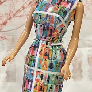 May include: A sleeveless doll dress with a colorful, geometric pattern featuring small figures in various outfits. The dress has a white belt and a fitted bodice, with a knee-length skirt. The overall design is vibrant and eye-catching.