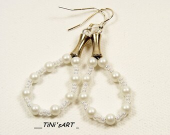 Silver earrings with white glass beads
