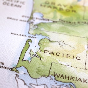 May include: A watercolor map of the Pacific Northwest region of the United States, showing the coastline of Washington state. The map features the Willapa Bay, Cape Disappointment, and the Wahkiakum County. The map is painted in shades of green, blue, and brown.