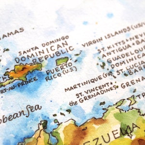May include: A watercolor map of the Caribbean islands, including the Bahamas, Dominican Republic, Haiti, Puerto Rico, and the Virgin Islands. The map is painted in shades of blue, green, and brown, with the names of the islands written in black.