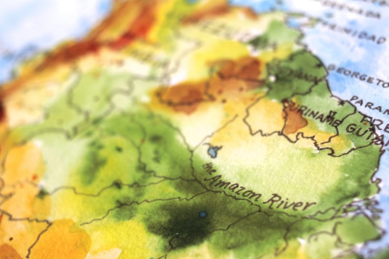 May include: A watercolor painting of a map of South America, with the Amazon River labeled in black text. The map is painted in shades of green, yellow, and brown.