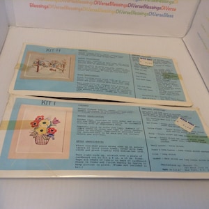 Peut inclure: Deux kits de broderie avec des instructions et un tableau de couleurs. Le premier kit, intitulé "KIT H", représente une scène d'hiver avec une maison, des arbres et un oiseau. Le deuxième kit, intitulé "KIT I", représente un panier de fleurs avec des fleurs rouges, jaunes et oranges.