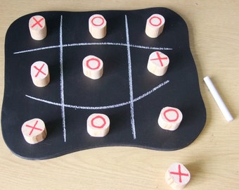 Noughts & Crosses game on a wooden chalk board with large wooden pieces. ideal for young children or people who can't handle small pieces.