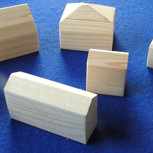 Set of ten blank unpainted little wooden houses for children to play with or model making scenery