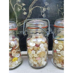 May include: A set of three ceramic mugs with a speckled, matte finish. The mugs are in shades of cream, light gray, and dark gray. Each mug has a simple, minimalist design, perfect for coffee or tea.