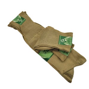 May include: Tan-colored socks, folded and packaged. Each pair is labeled with a green and white tag that reads "Packard Hosiery". The socks are made of a ribbed knit material.