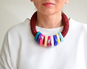 Statement necklace in t-shirt yarn and polymer clay rings.