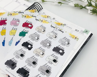 May include: Sheets of planner stickers featuring a couch design with the words "Lazy Day" in cursive. The stickers come in various colors, including red, yellow, and gray. A calendar is visible in the background.