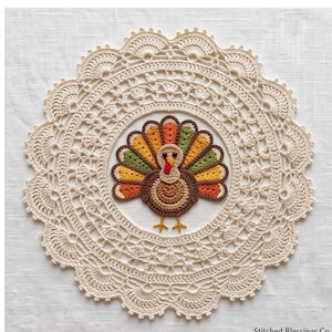 May include: A round, cream-colored crocheted doily featuring an intricate lace border and a central, multi-colored crocheted turkey applique. The turkey has a brown body, a red wattle, and a fan-shaped tail with orange, yellow, and green feathers.
