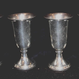 May include: A set of three ceramic mugs with a speckled, matte finish. The mugs are in shades of cream, light gray, and dark gray. Each mug has a simple, minimalist design, perfect for coffee or tea.