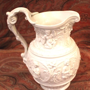 Antique Jasperware Pitcher – High Relief Cherub Design, Ram's Head Handle