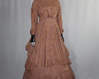 May include: A long, striped dress with a fitted bodice and a full skirt. The dress has a brown and yellow striped pattern and features multiple layers of ruffles at the hem.