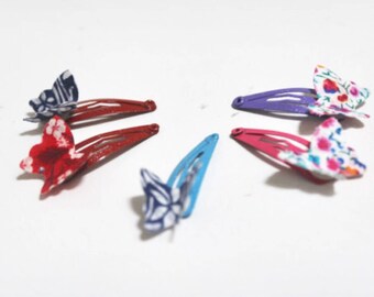 A pair of Liberty fabric butterflies on mini snap hair clips