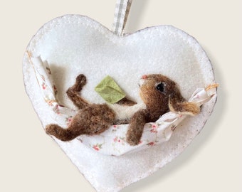 Felt heart rabbit relaxing in a hammock, hanging decoration for a loved one.