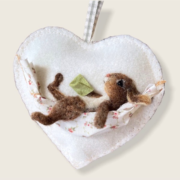 Felt heart rabbit relaxing in a hammock, hanging decoration for a loved one.