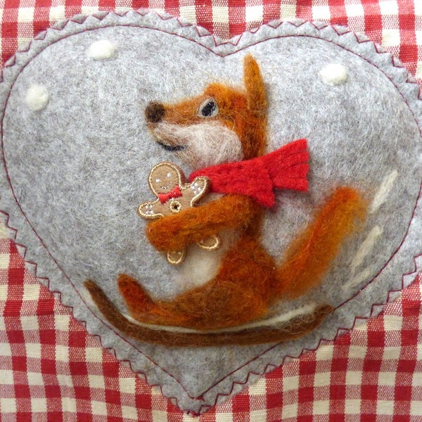 Needle felted sledging fox on a felt heart hugging his gingerbread man - scented with spices, animal enjoying the snow this Winter