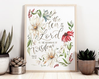 May include: A framed print with a white background and floral design. The text reads "The fear of the Lord is the beginning of wisdom" with the scripture reference "Psalm 111:10".