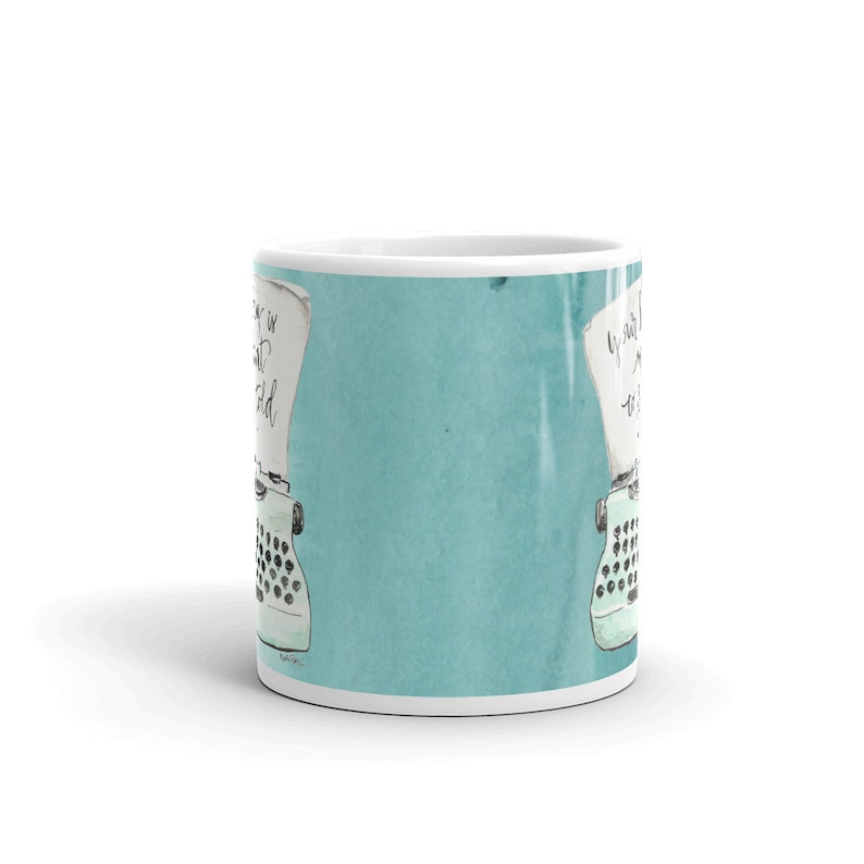 May include: A white ceramic mug with a teal blue background and a vintage typewriter illustration. The text on the mug reads "Every story is waiting to be told".