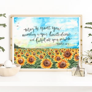 May include: A watercolor painting of a field of sunflowers with a blue sky and white clouds in the background. The painting has a quote from Psalm 20:4 that reads "May He grant you according to your heart's desire and fulfill all your purpose".