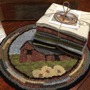 May include: A round, hand-stitched rug with a barn scene, featuring a red barn, green grass, and a blue sky. A stack of fabric squares and a matching printed design are tied together with twine. The rug's border has a variety of colors.