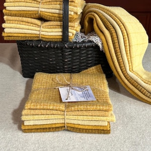 May include: A set of three ceramic mugs with a speckled, matte finish. The mugs are in shades of cream, light gray, and dark gray. Each mug has a simple, minimalist design, perfect for coffee or tea.