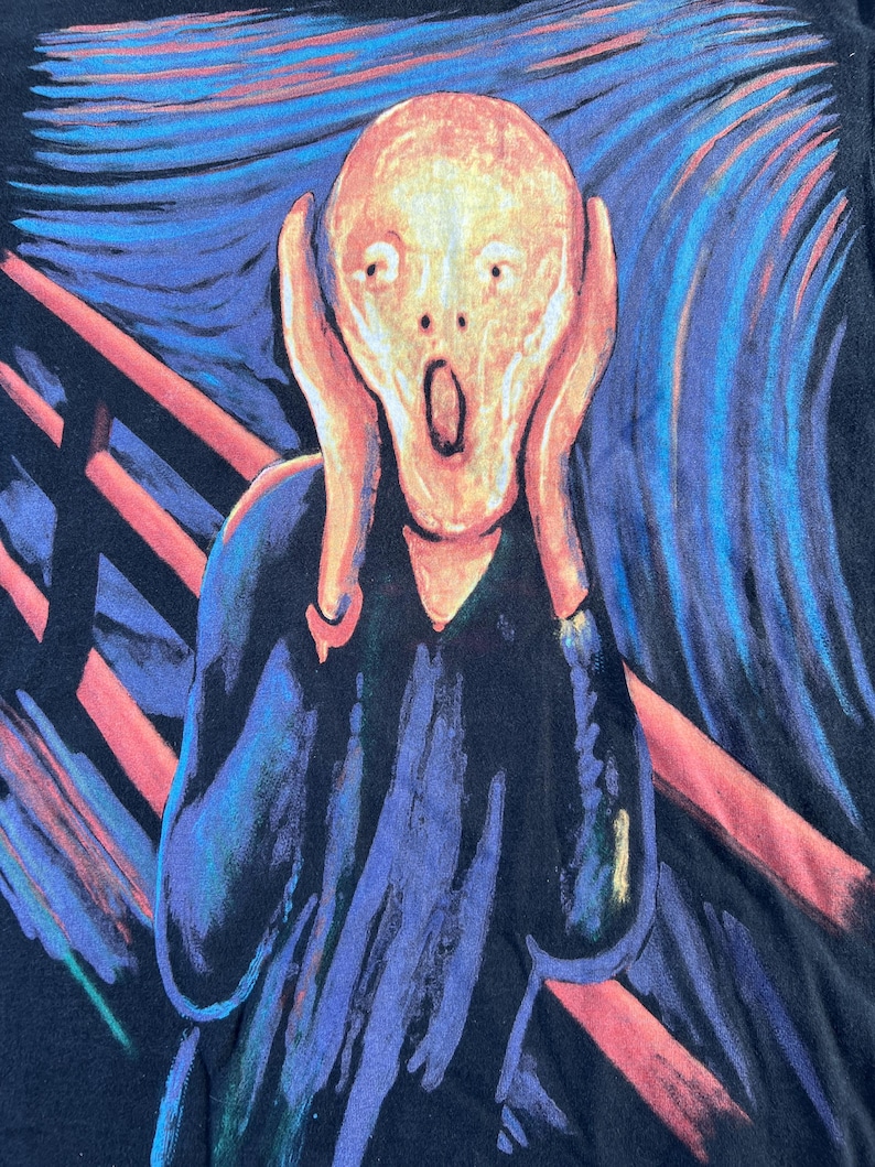 May include: A black t-shirt with a colorful print of Edvard Munch's The Scream painting. The painting features a figure with a pale face and a wide-open mouth, set against a swirling background of blue, red, and yellow.
