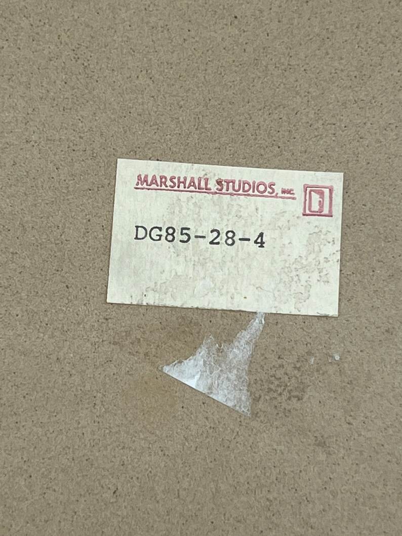 May include: A white label with the text "MARSHALL STUDIOS, INC." and a small square logo. Below the text is the number "DG85-28-4".