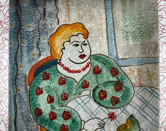 May include: A ceramic tile with a painting of a woman with blonde hair wearing a green dress with red flowers. She is sitting at a table with a pear and a red flower on the table. The tile has a blue and white background.
