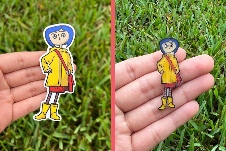 May include: A sticker featuring a cartoon character with blue hair, wearing a yellow raincoat, red skirt, and boots. The character has a red bag slung over their shoulder. The sticker is set against a background of green grass.