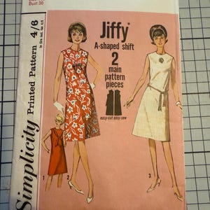 May include: Vintage Simplicity sewing pattern, style 5969, for a Jiffy A-shaped shift dress. The pattern includes two main pieces and is for a teen size 16t with a 91.4 cm bust. The cover art shows illustrations of the dress.