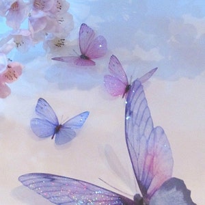 May include: A collection of delicate purple and pink butterflies with iridescent wings against a light blue background.