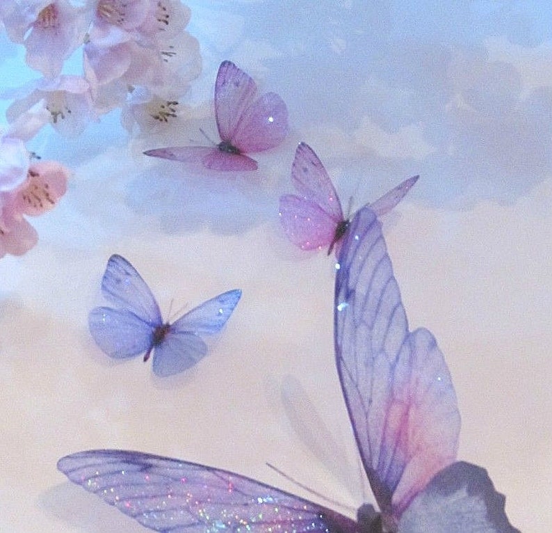 May include: A collection of delicate purple and pink butterflies with iridescent wings against a light blue background.