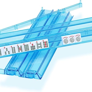 May include: Two translucent blue plastic Mahjong tile racks arranged in a cross pattern. The front rack holds a sequence of white tiles numbered one through nine in red and green, followed by three white tiles labeled Joker with a graphic icon.