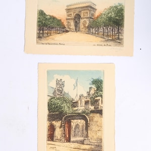 May include: Two rectangular paper prints featuring architectural illustrations. The top print depicts the Arc de Triomphe in Paris with trees and text. The bottom print shows a stone archway entrance to the Musee de Cluny with a flag and greenery.