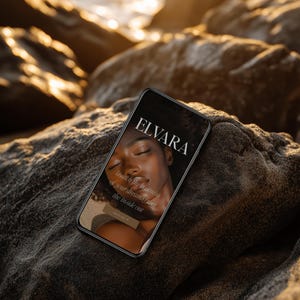 May include: A smartphone displaying the "ELVARA" logo and text "launch the business of your dreams from the inside out." The phone is resting on a dark, textured rock formation, with a blurred ocean and sunlight in the background.