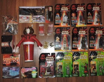 May include: A collection of Star Wars Episode I toys and collectibles, including action figures, trading cards, and a pencil pouch. The toys are packaged in their original boxes, which feature the Star Wars logo and Episode I branding. The collection also includes a red plastic cup with a Star Wars character on it.