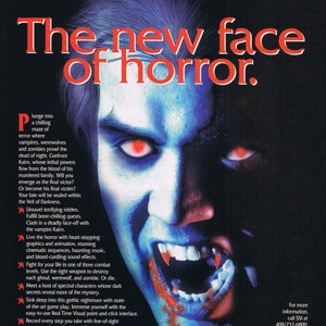 May include: A video game box cover for Veil of Darkness, a horror game featuring a vampire with glowing red eyes and fangs. The text on the cover reads "The new face of horror." and "Veil of Darkness".