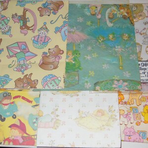 May include: Assortment of vintage wrapping paper featuring various designs, including a clown, a teddy bear, a baby in a cot, and a child on a swing. The paper is printed on a light yellow, light blue, and white background.