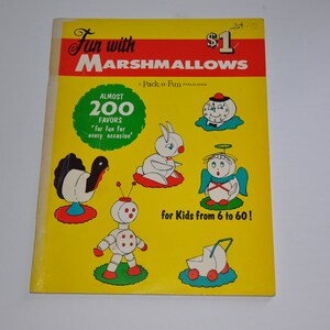 May include: A vintage book cover titled "Fun with Marshmallows" with a yellow background and cartoon illustrations of marshmallow characters. The cover includes text that reads "Almost 200 Favours for fun for every occasion" and "for Kids from 6 to 60!"