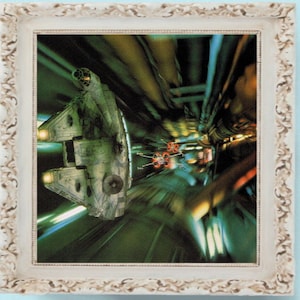 May include: A framed image of a spaceship flying through a tunnel of light. The spaceship is a Millennium Falcon, a popular spacecraft from the Star Wars franchise. The image is a vibrant green and blue with streaks of light.