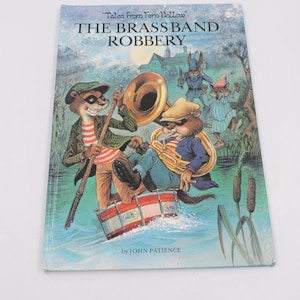 May include: A vintage children's book cover for "The Brassband Robbery" by John Patience. The illustration shows animal characters playing instruments in a river. The cover is light blue with the title in large, bold letters.