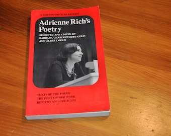 May include: A red book titled "Adrienne Rich's Poetry" with a black and white photo of the author on the cover. The book is a Norton Critical Edition and includes texts of the poems, the poet on her work, and reviews and criticism.
