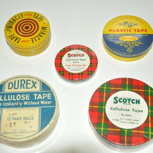 May include: Five vintage tape dispenser tins. The tins are round and have various colours and designs. One tin is yellow with red and black concentric circles and the text "Miracle Tape Clear". Another tin is yellow with a blue lid and the text "Free Cutter Inside Homart Plastic Tape Our Finest for Elastic Wiring Self Sealing 3/4 in. x 10 ft. No. 3001". A third tin is red and black plaid with the text "Scotch Brand Cellulose Tape No. 600 2 Rolls 1/2 in. x 2182 inches 13 mm x 5544 cm". A fourth tin is red and black plaid with the text "Scotch Cellulose Tape 881/2 Large Economy Size 1 Roll 1 1/2 in. x 192 inches 38 mm x 4877 cm Transparent". The fifth tin is blue with a white lid and the text "Durex Cellulose Tape Seals Instantly Without Water Patented Carbon 1931 1940 1943 72 Yard Rolls Canadian Durex Adhesives Ltd. Toronto".
