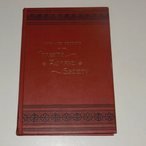 May include: A red book with a gold title that reads "Letters and Papers of the Toronto Rumane Society". The book has a black and gold decorative border.