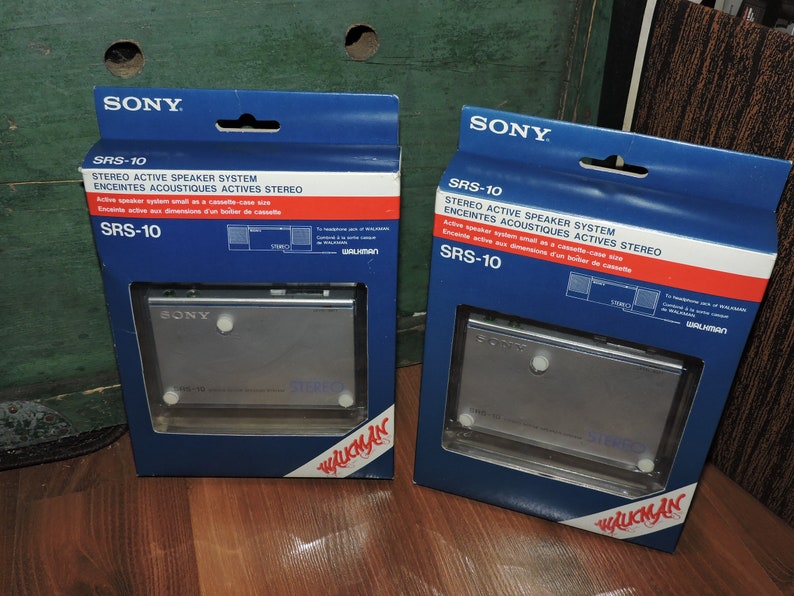 May include: Two blue and white boxes with the Sony logo and the text "SRS-10 Stereo Active Speaker System" on the front. The boxes contain a small, silver cassette player with the Sony logo on the front. The boxes are labeled "Walkman" on the bottom.