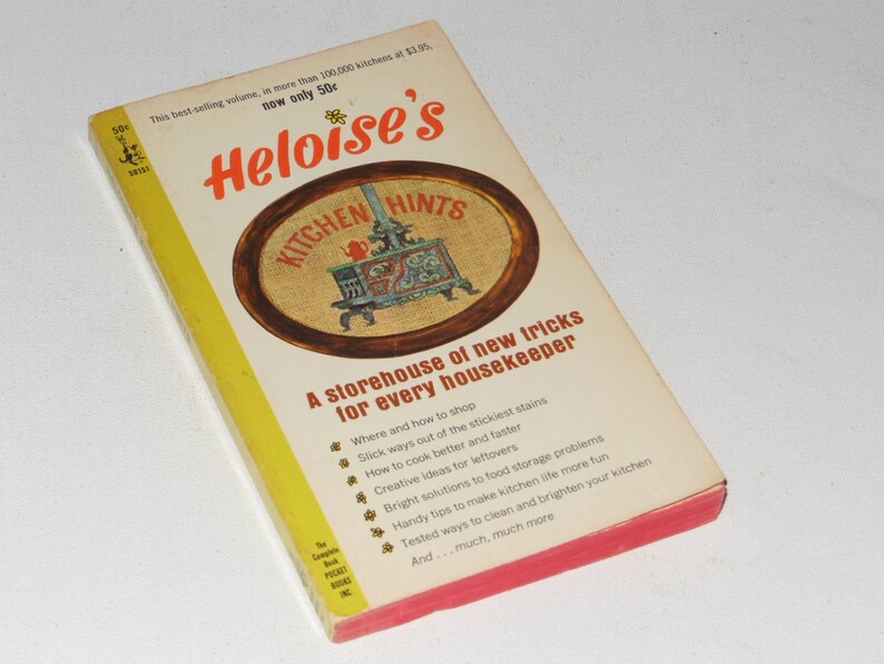 May include: A yellow and red book titled "Heloise's Kitchen Hints" with a picture of a stove on the cover. The book is a storehouse of new tricks for every housekeeper.